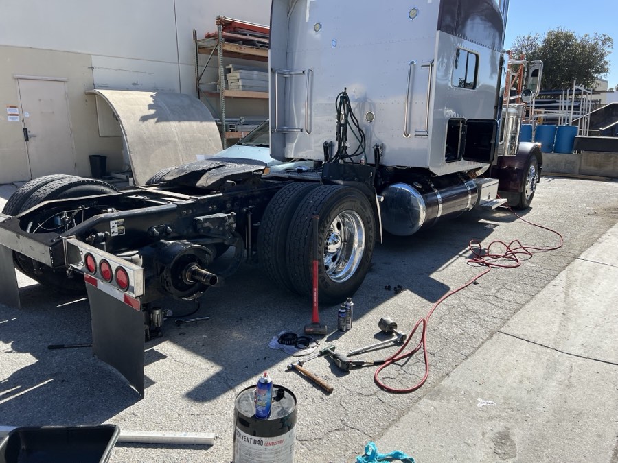 Peterbilt sleeper truck with rear wheels off during an axle repair