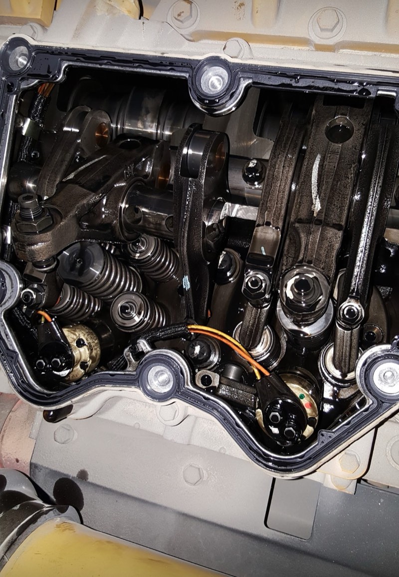 Diesel engine valve train opened up for diagnosis and adjustment